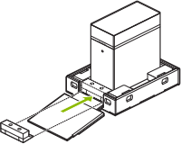 Line drawing showing the front packing piece being inserted into the bottom tray of the DGX Station shipping carton.