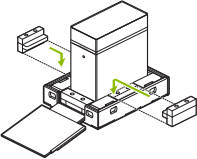 Line drawing showing side packing pieces being inserted into the bottom tray of the DGX Station shipping carton.